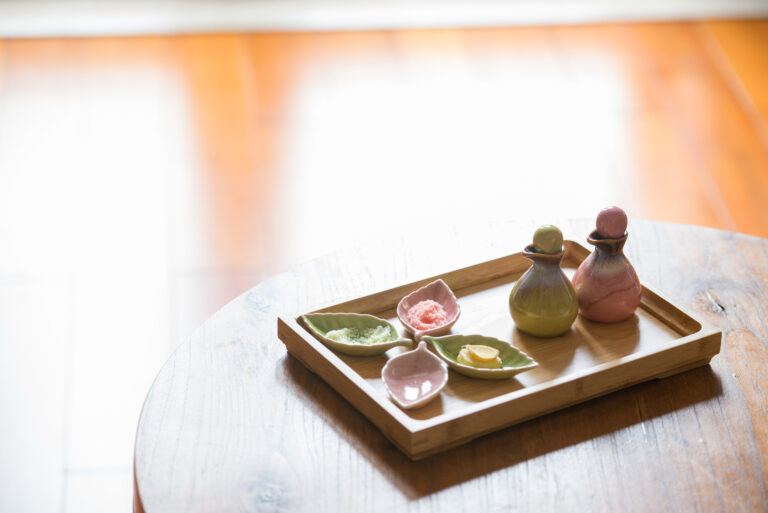 porcelain bottle and plate with bath salt put on the table